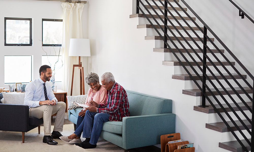 An agent from Premier Choice Insurance helping a Mesa homeowner review their policy to lower premiums — find out how to save on homeowners insurance and request your personalized coverage plan today.